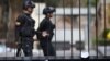 Members of Venezuelan security forces are seen on the background as documents regarding a proposed amnesty law for members of the military, police and civilians stand in a fence in Caracas, Venezuela, January 27, 2019.