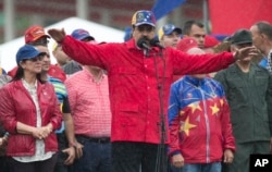 FILE - Venezuela's President Nicolas Maduro speaks during an anti-imperialist rally in Caracas, Venezuela, March 9, 2017. In an effort to stave off protests against him, Maduro pledged in a televised appearance Sunday that he will raise the country's minimum rage by 60 percent.