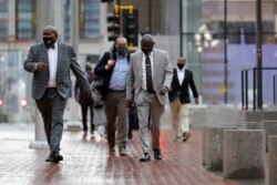 Floyd family lawyer Ben Crump and members of the Floyd family walk outside the Hennepin County Government Center, site of the trial of former police officer Derek Chauvin, in Minneapolis on April 6, 2021.