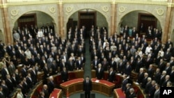 Hungary's newly elected president, Janos Ader (C), takes his oath of office in parliament in Budapest, May 2, 2012. 