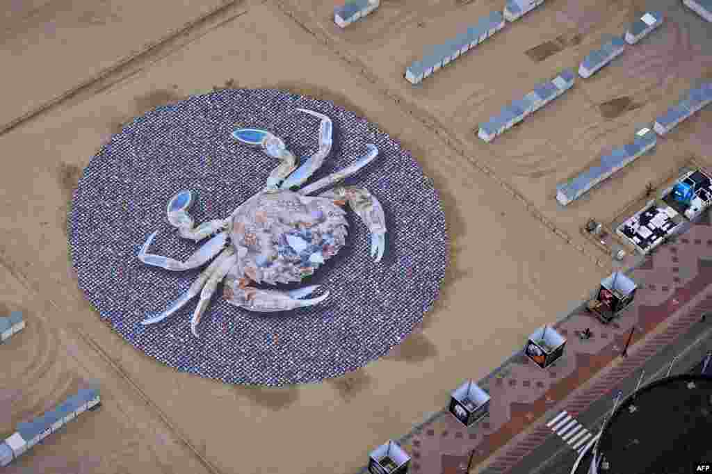 An aerial picture above the Knokke-Heist beach shows the art installation of photographer Wim Tellier entitled &quot;Time&quot; and depicting a giant crab.