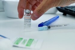 A healthcare worker prepares a syringe at a monkeypox vaccination clinic in Montreal, Quebec, Canada, on June 6, 2022. (Christinne Muschi/Reuters)