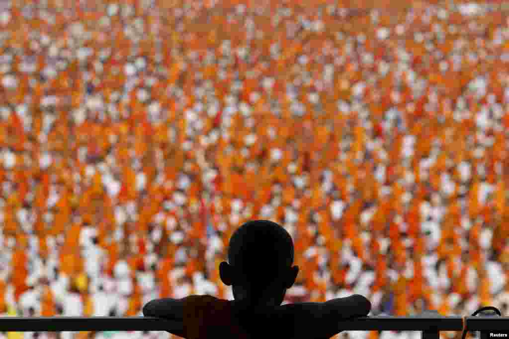 Buddhist monks and novices gather to receive alms at Wat Phra Dhammakaya temple, in what organizers said was a meeting of over 100,000 monks, in Pathum Thani, outside Bangkok, Thailand.