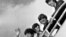 FILE - The Beatles, from left, Paul McCartney, Ringo Starr, John Lennon and George Harrison board a plane for England at a New York airport with some of their fans in the background, Sept. 21, 1964. 