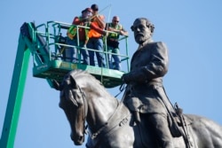 An inspection crew from Virginia takes measurements as they inspect the statue of Confederate Gen. Robert E. Lee June 8, 2020, in Richmond, Va. Virginia Gov. Ralph Northam has ordered the removal of the statue. (AP Photo/Steve Helber)