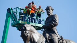 An inspection crew from Virginia takes measurements as they inspect the statue of Confederate Gen. Robert E. Lee June 8, 2020, in Richmond, Va. Virginia Gov. Ralph Northam has ordered the removal of the statue. (AP Photo/Steve Helber)