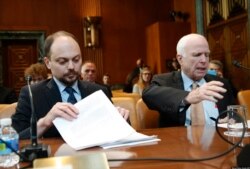 March 29, 2017: Russian opposition activist Vladimir Kara-Murza (left) and Senator John McCain prepare to testify before a Senate committee hearing on Russia.