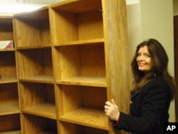 Rebecca Maitland and historian John Ritter found a long-forgotten room behind this bookcase in the basement of a Salem office building.