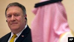 U.S. Secretary of State Mike Pompeo, left, listens to Saudi Arabia's Foreign Minister Adel al-Jubeir, during a joint press conference at the Royal Terminal of King Khaled airport, in Riyadh, Saudi Arabia, Sunday, April 29, 2018. ob