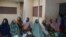 A group of women in Kano, Nigeria, wait to have patches removed from their eyes following cataract surgery. (Isiyaku Ahmed/VOA News) 