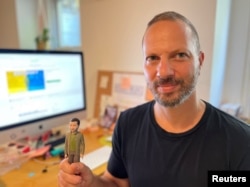 Jason Feinberg, FCTRY CEO & creative director, with a prototype of the Zelenskiy action figure in Brooklyn, NY, August 9, 2022. (REUTERS/Roselle Chen)
