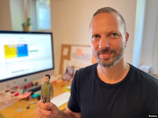 Jason Feinberg, FCTRY CEO & creative director, with a prototype of the Zelenskiy action figure in Brooklyn, NY, August 9, 2022. (REUTERS/Roselle Chen)