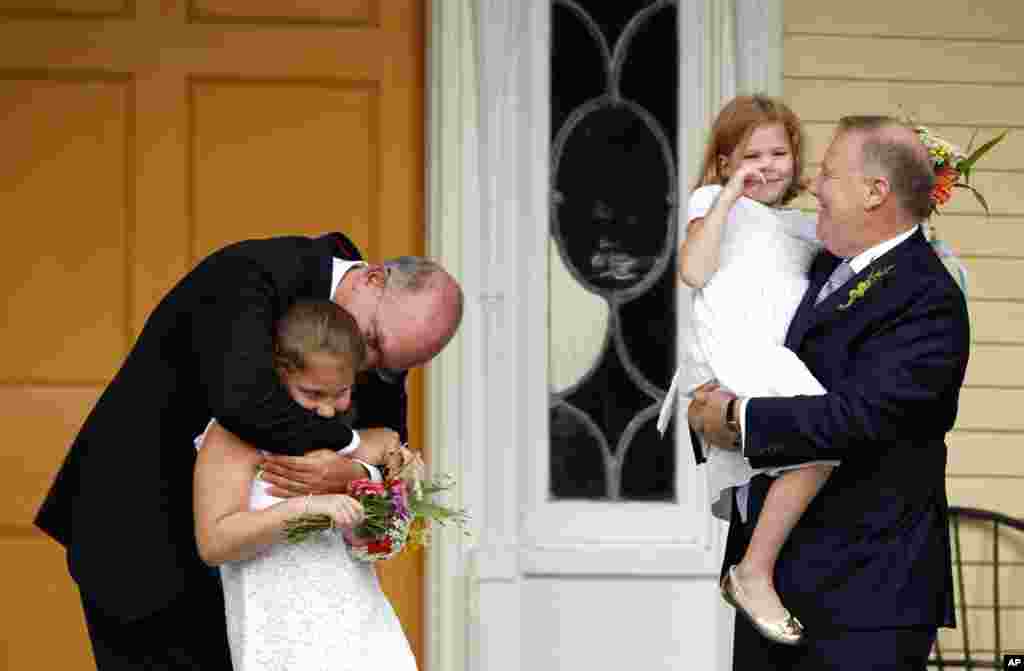 On July 24, 2011, the first day that gay couples were allowed to legally marry in New York state, John Feinblatt (R) and Jonathan Mintz (L) celebrate their marriage with their daughters. Mayor Michael Bloomberg officiated the wedding. (Reuters)