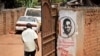 In this Thursday, Sept. 20, 2018 file photo, a man walks past graffiti in support of pop star-turned-opposition lawmaker Bobi Wine, whose real name is Kyagulanyi Ssentamu, in the Kamwokya neighborhood where he has many supporters.