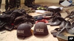 Soldiers stand behind items recovered from suspected Boko Haram members, Bukavu Barracks in Kano, Nigeria, March 21, 2012 (file photo).
