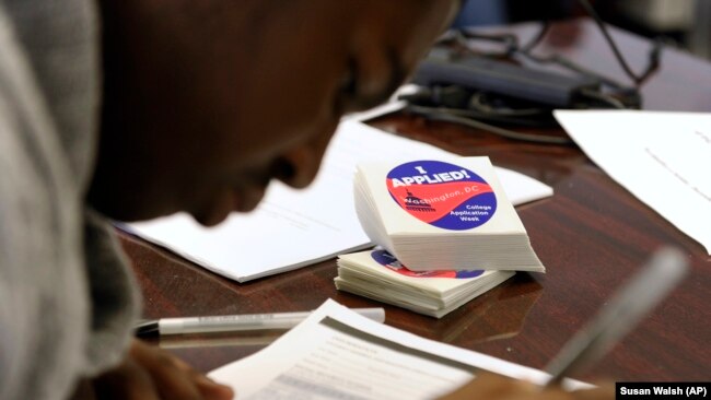 A student at Roosevelt High School in Washington, DC fills out a college enrollment application. President Barack Obama’s goal is that by 2020, America will again have the highest proportion of college graduates in the world.