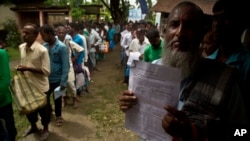 People whose names were left out in the National Register of Citizens (NRC) draft stand in a queue to collect forms to file appeals near a NRC center on the outskirts of Gauhati, India, Monday, Aug. 13, 2018. (AP Photo/Anupam Nath)