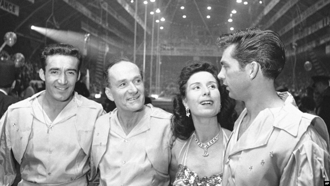 FILE - Karl Wallenda, center left, and his daughter Jenny, center right, wait on sideline with troupe members Louis Murillo, left, and Andy Anderson, before performing a high-wire act at the opening of the Shrine Circus in Detroit, Jan. 24, 1964.