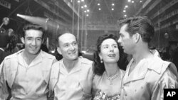 FILE - Karl Wallenda, center left, and his daughter Jenny, center right, wait on sideline with troupe members Louis Murillo, left, and Andy Anderson, before performing a high-wire act at the opening of the Shrine Circus in Detroit, Jan. 24, 1964.