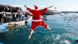 A person dressed as Santa Claus jumps into the sea during the Copa Nadal (Christmas Cup) swimming race in Barcelona, Spain, Dec. 25, 2024. 