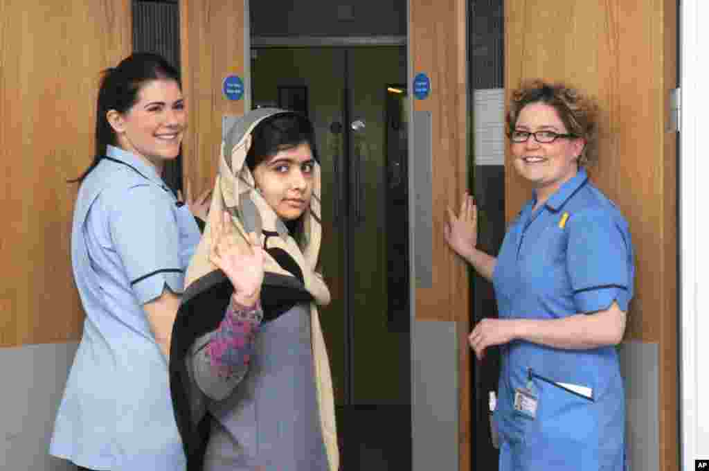 This photo made available by Queen Elizabeth Hospital shows Malala Yousafzai saying goodbye as she is discharged from the hospital to continue her rehabilitation at her family’s temporary home in the area, January 4, 2013.