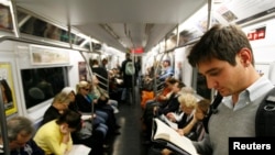 People who take public transportation, like these commuters on the New York City subway, are able to relax, read and avoid traffic. (FILE PHOTO/October 2008)