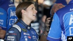 Danica Patrick smiles in the garage during practice for Sunday's NASCAR Cup Series auto race at Homestead-Miami Speedway in Homestead, Florida, Nov. 17, 2017.