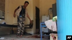 A Yemeni man inspects an elderly care home after it was attacked by gunmen in the port city of Aden, Yemen, March 4, 2016. Unidentified gunmen stormed a retirement home, killing more than a dozen people. 