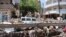 FILE - People inspect damage caused by flooding on a street in Aden, Yemen, April 22, 2020.