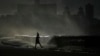 A person fishes along the boardwalk as waves crash in Havana, Oct. 21, 2024.