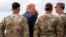 President Donald Trump greets member of the military as he arrives on Air Force One at Wheeler-Sack Army Air Field in Fort Drum, N.Y.
