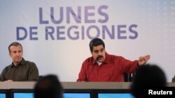 Venezuela's President Nicolas Maduro, right, speaks during a meeting with ministers, next to Venezuela's Vice President Tareck El Aissami, in Caracas, Venezuela, March 26, 2018.