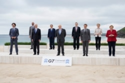 Leaders of the G7 pose for a group photo on overlooking the beach at the Carbis Bay Hotel in Carbis Bay, St. Ives, Cornwall, England, June 11, 2021.