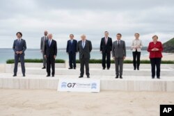 Leaders of the G7 pose for a group photo on overlooking the beach at the Carbis Bay Hotel in Carbis Bay, St. Ives, Cornwall, England, June 11, 2021.