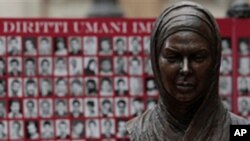 Bust of Iranian Protest Victim Neda Agha Soltan , a student killed during election protests in Tehran in 2009, is seen in front of a banner showing pictures of what Iranian opposition groups say are victims of the Iranian regime.