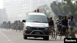 FILE – A traditional ambulance rushes past trishaws on a highway in Gazipur, 50 km (31 miles) from the capital Dhaka, Dec. 4, 2006.