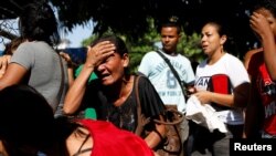 Relatives of inmates at the General Command of the Carabobo Police react as they wait outside the prison in Valencia, Venezuela, March 28, 2018.