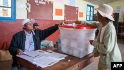 A voter casts her ballot at a polling station in Antananarivo, on November 16, 2023, during the first round of Madagascar's presidential election.