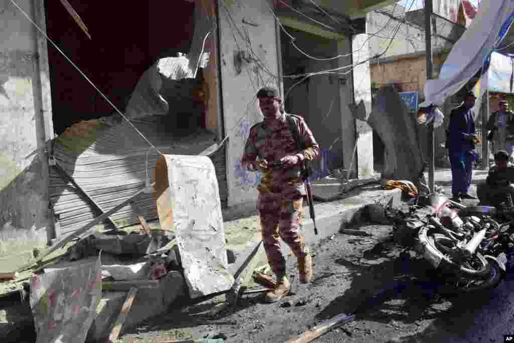 A security official checks the site of a bomb blast in Quetta, Pakistan.