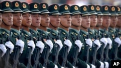 FILE - Chinese People's Liberation Army soldiers march in formation during a parade to commemorate the 70th anniversary of the founding of the People's Republic of China in Beijing, Oct. 1, 2019.