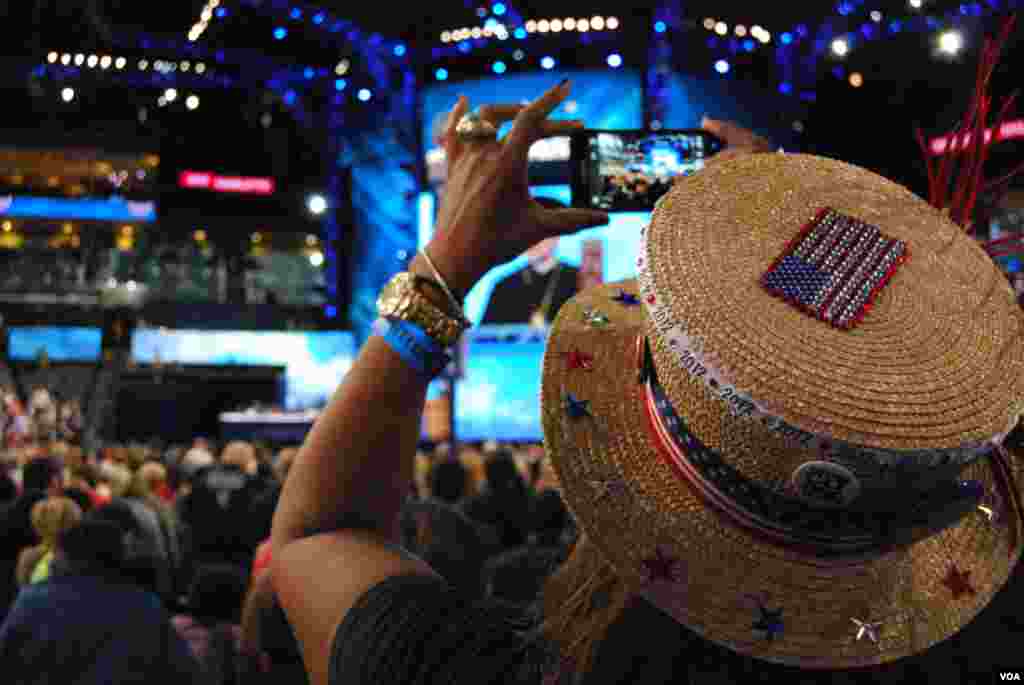 A woman records the invocation at the Democratic National Convention, Charlotte, North Carolina, September 4, 2012. (J. Featherly/VOA)