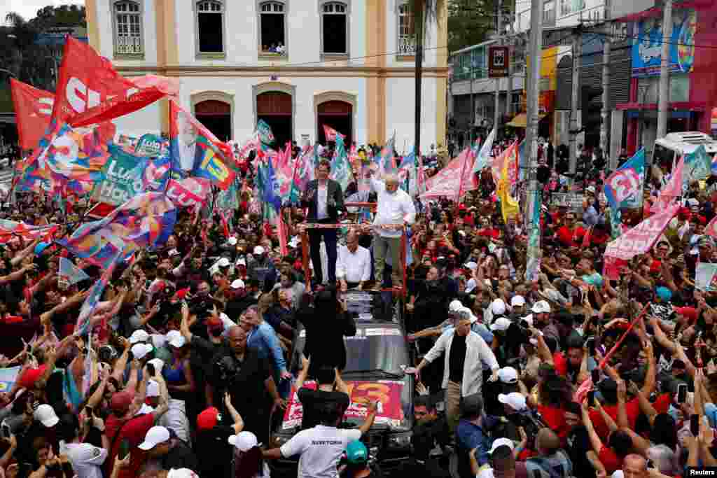 Former President of Brazil and current presidential candidate Luiz Inacio Lula da Silva and Sao Paulo Governor candidate Fernando Haddad greet supporters during a march in Guarulhos, Sao Paulo state, Brazil.