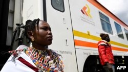 FILE - People disembark from a train in Kimuka on the Standard Gauge Railway (SGR) line constructed by the Chinese Communications Construction Company (CCCC) and financed by Chinese government, Oct. 16, 2019 .