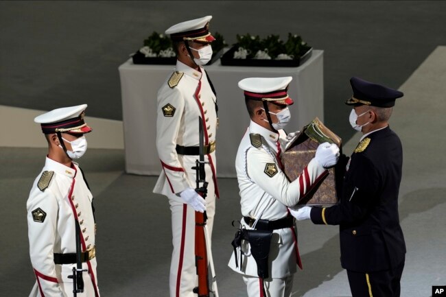 Color guards carry the remains of former Prime Minister of Japan Shinzo Abe during the state funeral Tuesday Sept. 27, 2022, at Nippon Budokan in Tokyo. (AP Photo/Eugene Hoshiko, Pool)