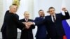 From left to right, the Moscow-appointed heads of Kherson region Vladimir Saldo and Zaporizhzhia region Yevgeny Balitsky, Russian President Vladimir Putin, Donetsk separatist leader Denis Pushilin and Lugansk separatist leader Leonid Pasechnik join hands 