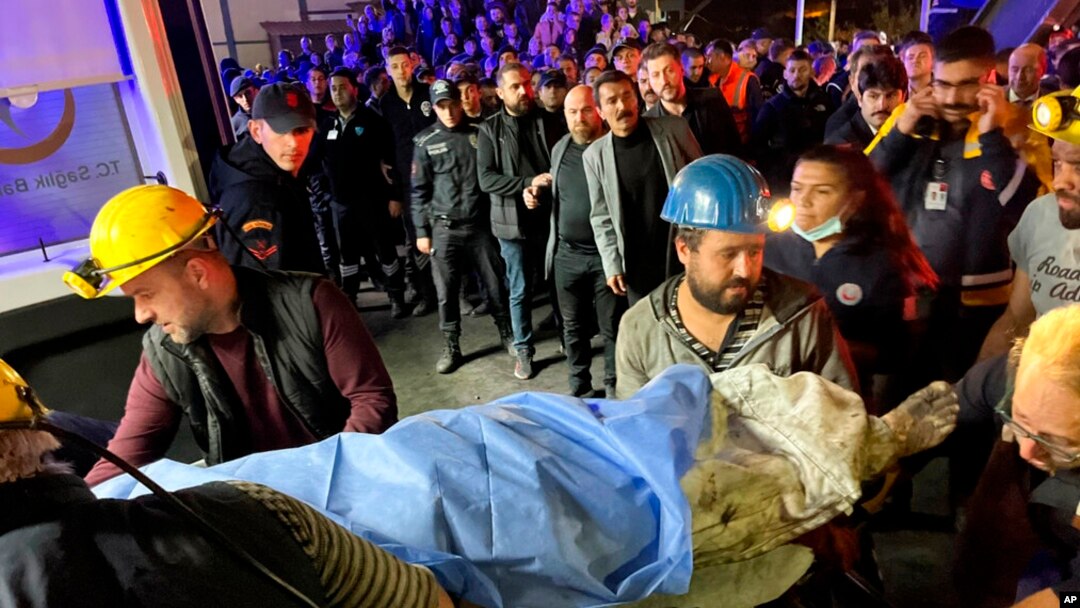 Miners carry the body of a victim in Amasra, in the Black Sea coastal province of Bartin, Turkey, Oct. 14, 2022, after an explosion in a coal mine. 