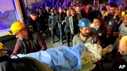 Miners carry the body of a victim in Amasra, in the Black Sea coastal province of Bartin, Turkey, Oct. 14, 2022, after an explosion in a coal mine. 