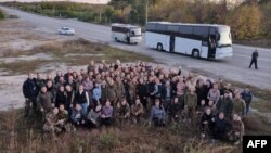 This handout picture taken and released by Ukrainian presidential chief of staff, Andriy Yermak, on Oct. 17, 2022 shows freed Ukrainian female prisoners posing for a picture after their exchange in an unknown location in Ukraine.