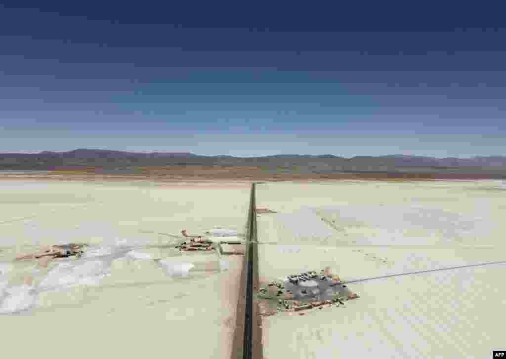 Aerial view of a salt mining site (L) and a parking area in the Salinas Grandes salt flat in the northern province of Jujuy, Argentina.