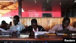 FILE - Displaced South Sudanese students take a maths examination in the disco club in the United Nations base in Juba, Jan. 17, 2014. 